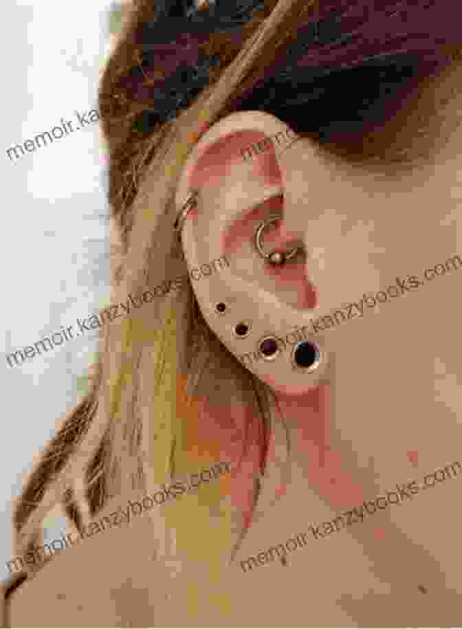 A Close Up Of A Person's Ear With Stretched Lobes And Multiple Piercings. ALL ABOUT EAR STRETCHING AND PIERCING: The Ultimate Guide On How To Stretch And Pierce Your Ear