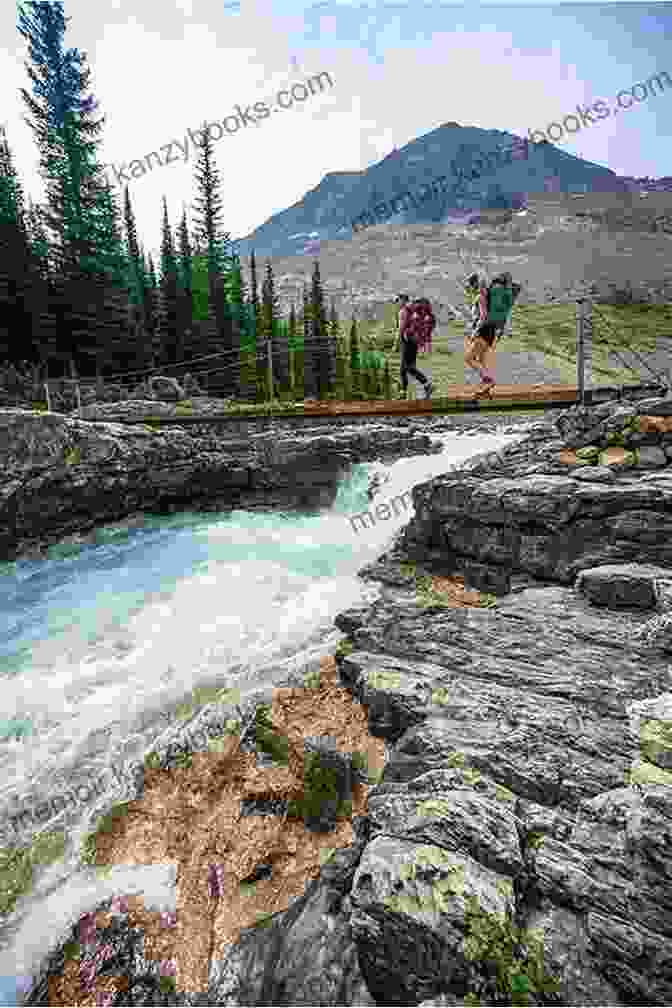 Hikers Crossing A Suspension Bridge Over A Glacier Fed River Trekking In The Alps (Mountain Walking)